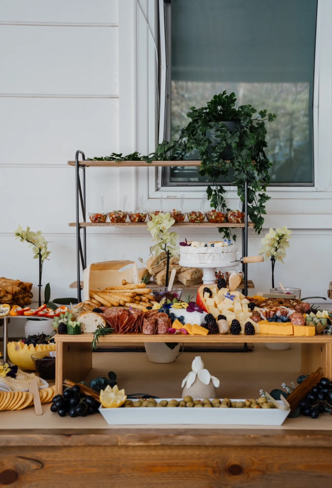 L’Amore grazing board with cheese, honey, fruit, and crackers on marble